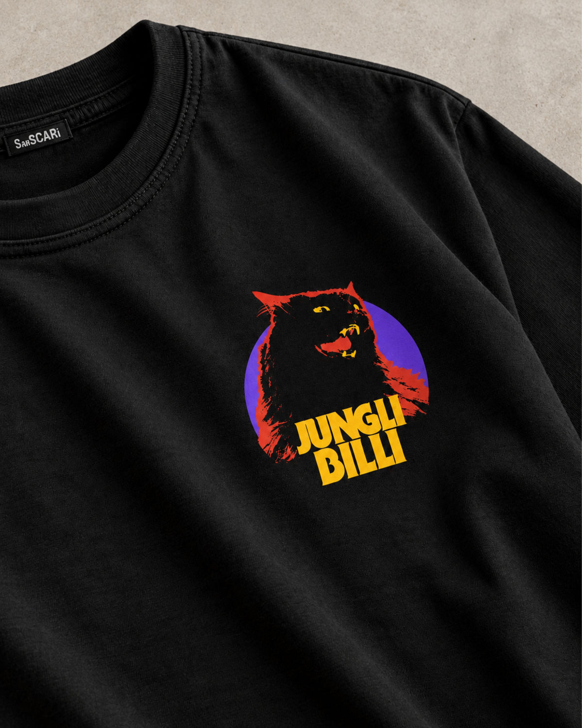 Jungli Billi black oversized tee laid flat, close-up of the cat print