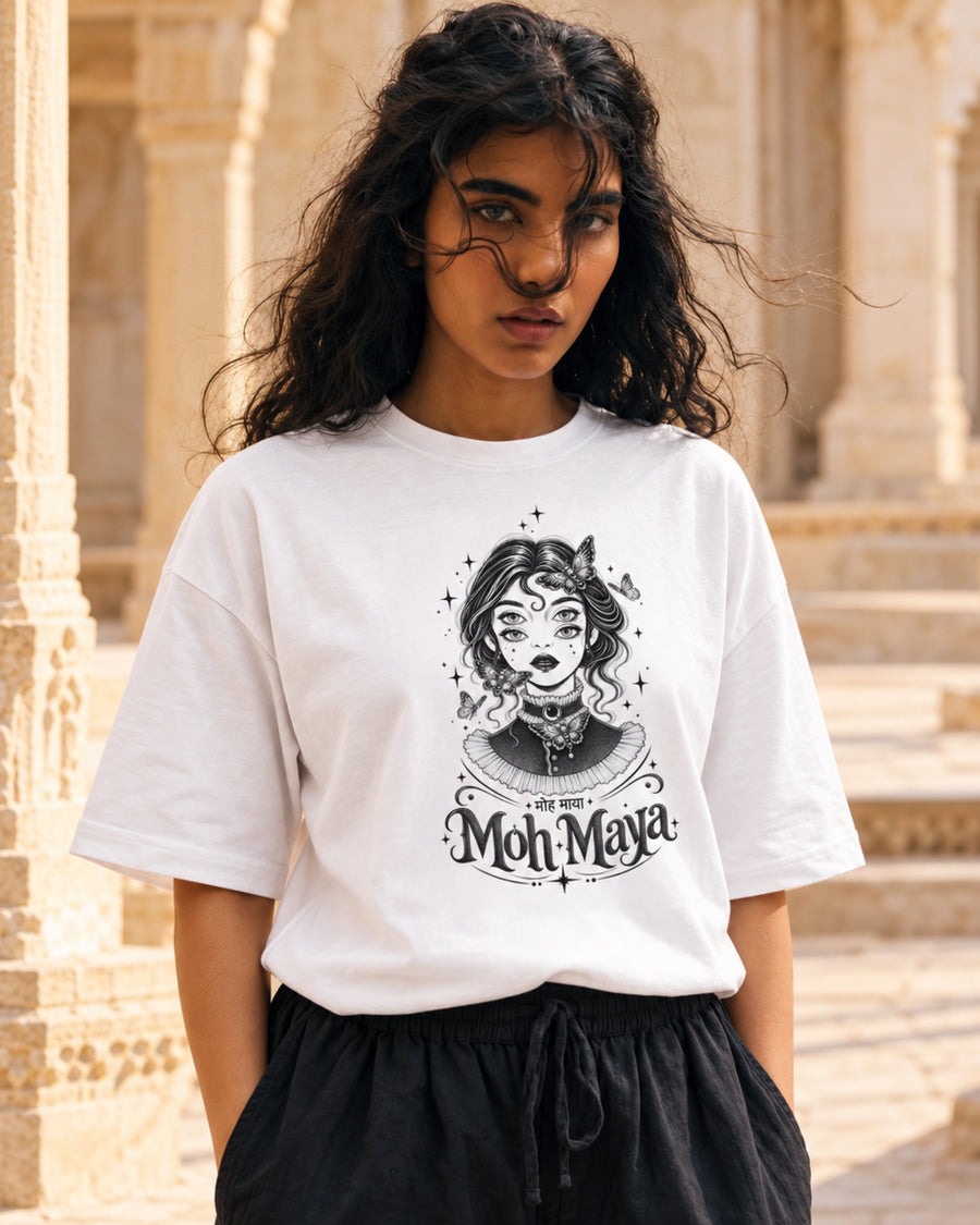 Model in the white Moh Maya tee on sandstone steps