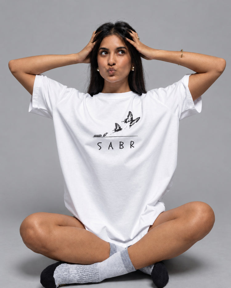 SABR white oversized tee with a butterfly print, worn by a model