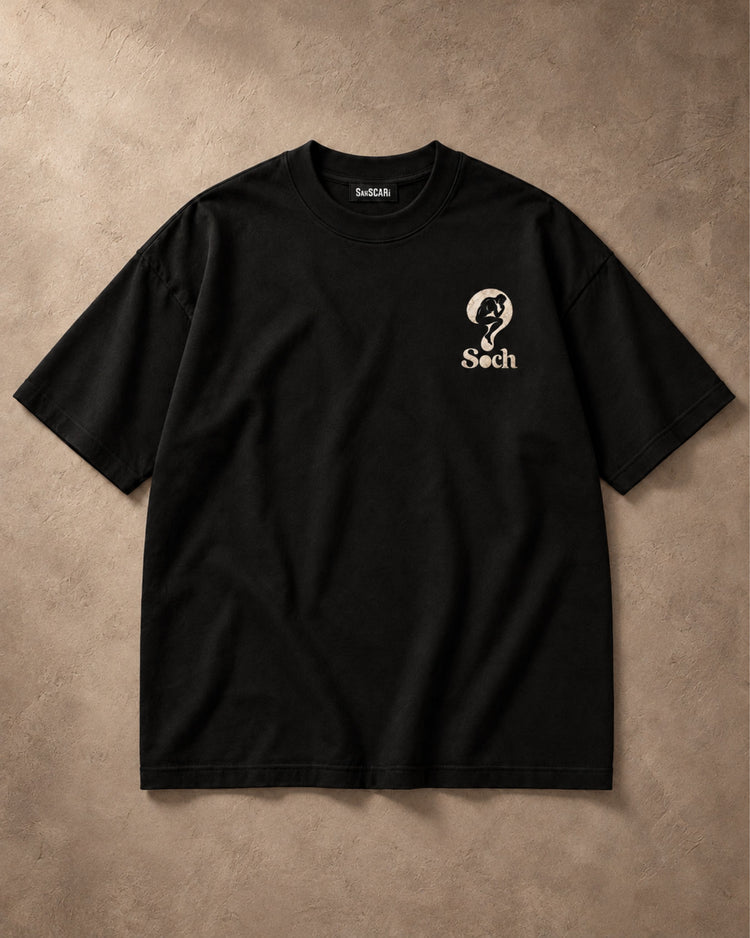 Soch black oversized tee, full front on a stone background