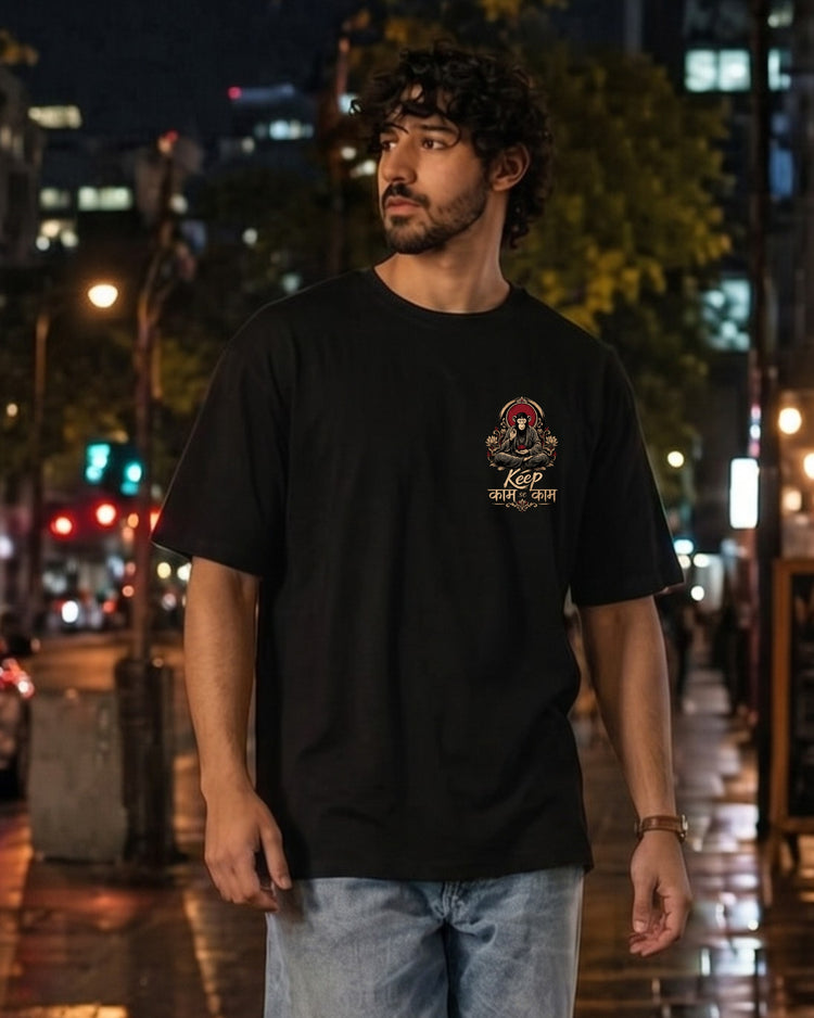 Keep काम se काम black tee worn on a city street at night