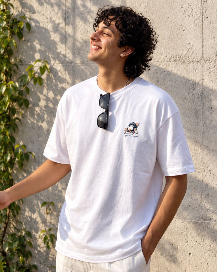 Model smiling in the Apna Time Aayega white oversized tee
