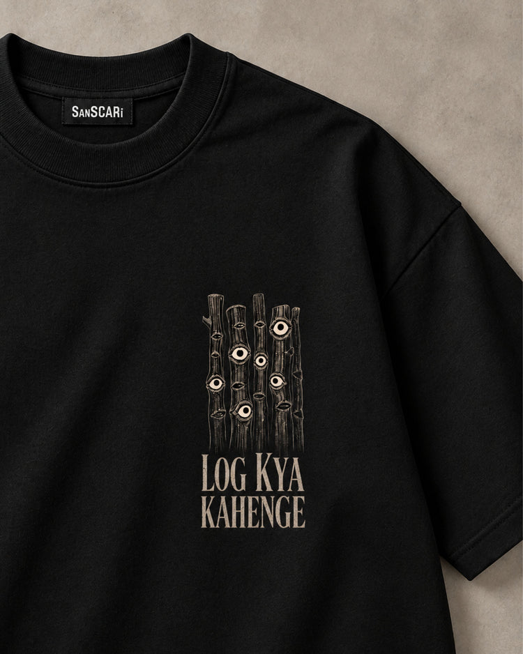 Log Kya Kahenge? black oversized tee laid flat, close-up of the eyes print